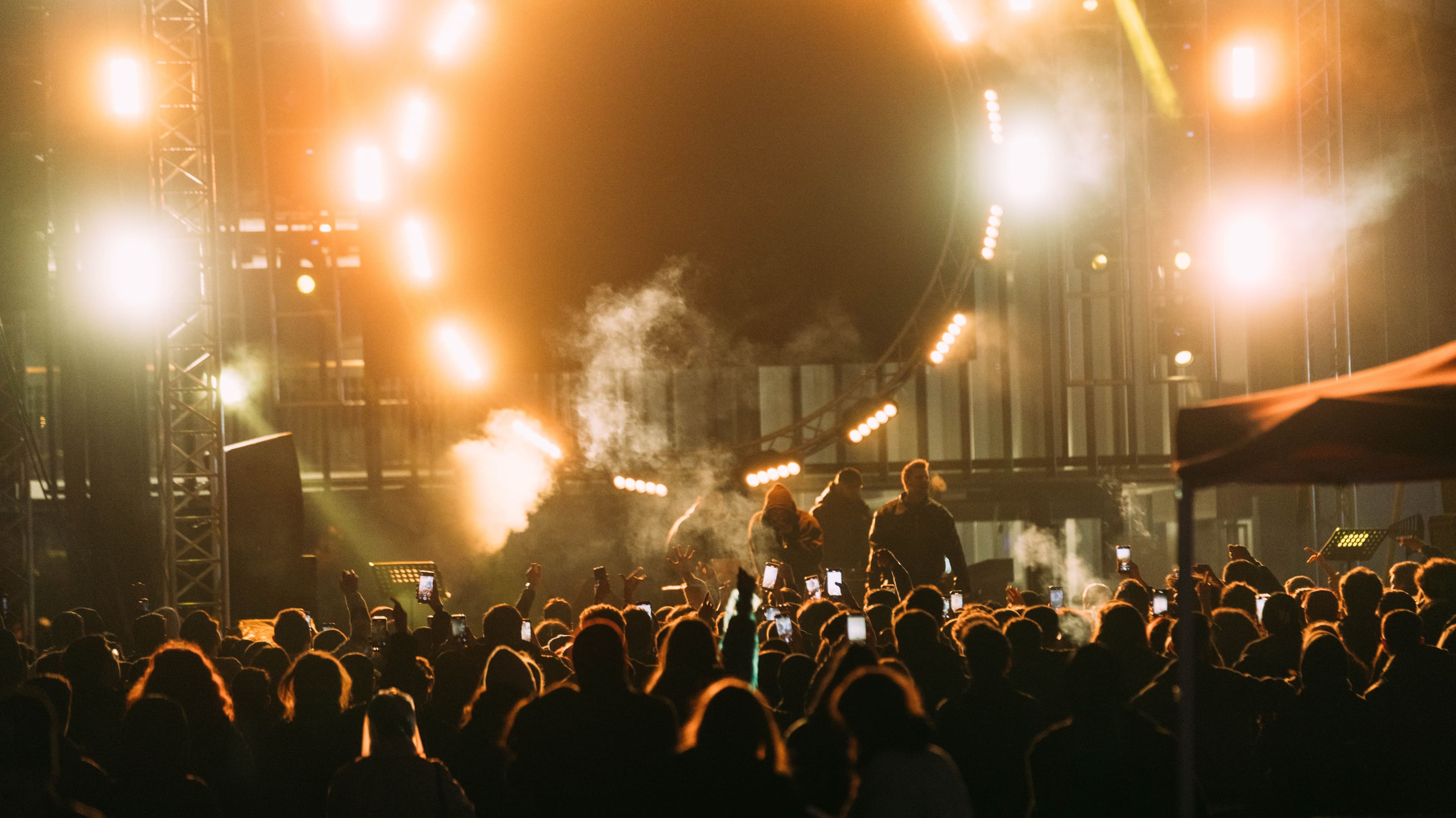 Musician performing for a large outdoor crowd