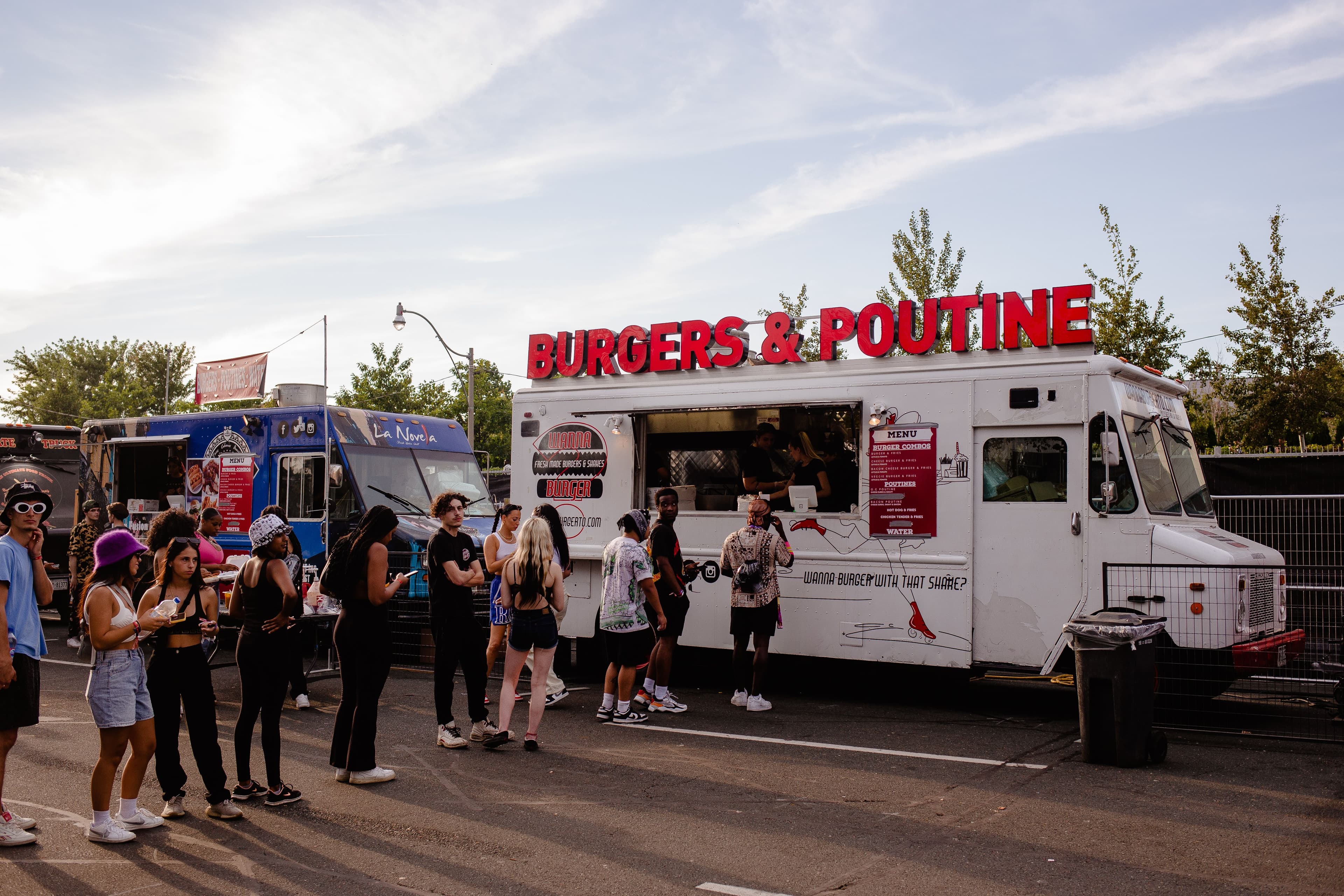 Festival guests gathering at illuminated food vendors